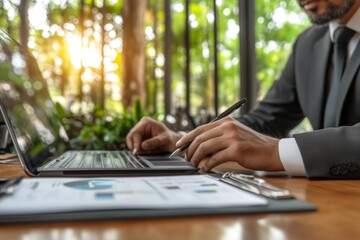 Poster - An image of a business woman signing on a digital tablet while working at her home office on a laptop computer on a table, while being online, while internet networking.