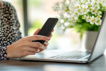 Poster - A business woman uses her mobile phone while working on a laptop at home. A freelancer is working online and using a smartphone.