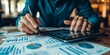 © kwanchaift - Financial planner creating a budget plan on a tablet interactive charts and detailed financial data modern digital interface
