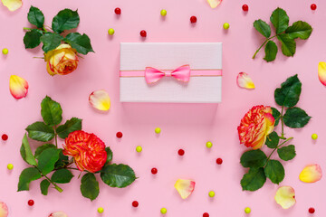 Sticker - Gift box with bouquet of red roses on pink table. Greeting card for the holiday. Creative banner.