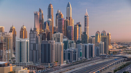 Dubai Marina skyscrapers aerial top view at sunrise from JLT in Dubai timelapse, UAE.