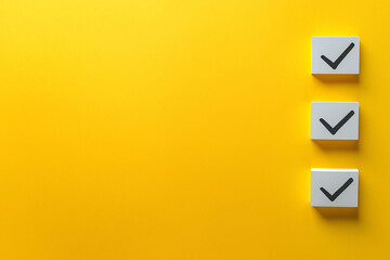 Poster - Three checkmark boxes on vibrant yellow background symbolize completion and success.