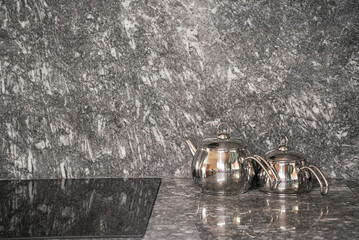  Two Turkish metal teapots on the modern grey kitchen.