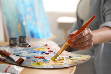 Sticker - Woman with brush using palette at table indoors, closeup