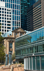 Wall Mural - historic building in the middle of a big city jungle with skyscrapers in the background