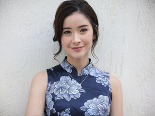 Woman floral dress smile. Beautiful woman in a blue floral dress, smiling and looking at the camera.