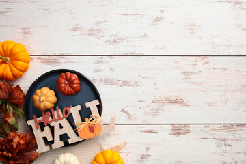 Wall Mural - Festive autumn decor and pumpkins on rustic wooden table. Top view.