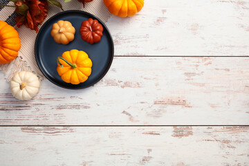 Wall Mural - Rustic autumn wooden table with pumpkins and dry flowers. Autumn, fall concept.