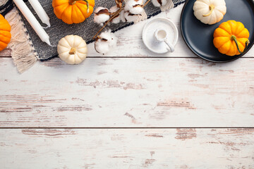 Wall Mural - Flat lay composition with plaid, pumpkins, autumn decor on white wooden desk table. Cozy fall atmosphere.