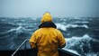 ©  Jovaduplex - Back view of a person wearing a yellow rain suit, enduring stormy sea conditions on a boat. This image captures human perseverance against adverse weather.