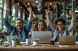 © Sunshine - Group of people, business team are smiling and holding up their hands in the air, sitting at a desk with laptops and other office supplies