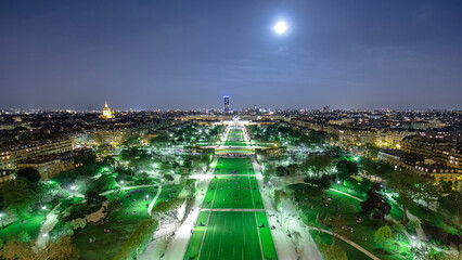 Wall Mural - Champs de Mars from the Eiffel tower at night with rising Moon timelapse