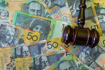 Canvas Print - judge hammer with australian dollar money on desk.  Crime corruption concept a