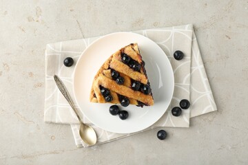 Canvas Print - Slice of delicious homemade blueberry pie served on light table, flat lay