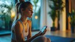 © panu101 - Fit woman watching online exercise class on smartphone in sunny courtyard