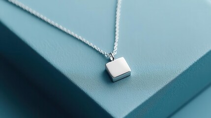 Wall Mural - Minimalist silver necklace with a small square charm, close-up, soft natural light, neutral background