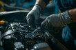 © Mikhail Vorobev - Mechanic repairing car engine with wrench in garage workshop  close up of hands and tools