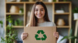© olyphotostories - Woman holding cardboard box with recycling sign stamp at home. Ecological sustainable fashion. Fabrics recycling. Reduce waste concept. conscious clothing consumption.