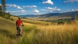 © Popelniushka - Male Mountain Biker Taking a Break on Mt. Sentinel in Missoula, MT. Caucasian Cyclist in Casual Attire Resting in Grass Field
