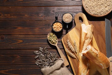 Poster - Different types of cereals, seeds and legumes on wooden table, flat lay. Space for text