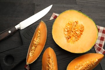 Wall Mural - Fresh ripe Cantaloupe melon and knife on dark wooden table, flat lay