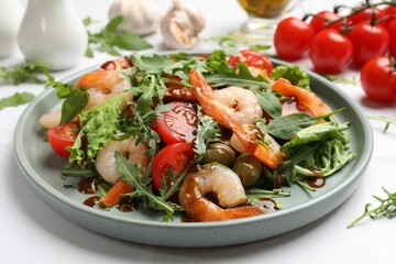 Delicious shrimp salad with vegetables on white table, closeup