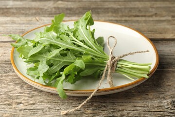 Sticker - Bunch of fresh green arugula leaves on wooden table, closeup