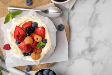 Sticker - Pavlova cake (meringue dessert) with whipped cream, fresh berries and mint on white marble table, flat lay. Space for text