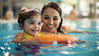 © Frank Gärtner - Smiling mother is helping her young daughter learn to swim in an indoor pool while wearing inflatable armbands