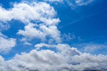 Wall Mural - a beautiful blue sky with white fluffy clouds in the background. this scene is perfect for a relaxin