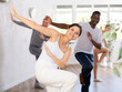 © JackF - Active sporty men and women of different ages practicing Hip-hop dance in training hall during dancing classes