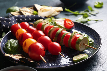 Wall Mural - Plate with tasty grilled vegetables on blue background