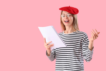 Wall Mural - Female author with paper sheets on pink background