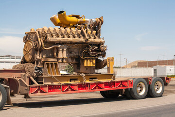 Large industrial machine engine on a trailer for transport