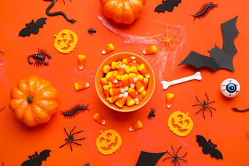 Poster - Composition with bowl of sweet candy corns and Halloween decorations on orange background