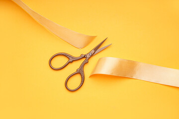 Canvas Print - Cut satin ribbon and scissors on yellow background