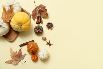 Wall Mural - Autumn composition with candles, pumpkins and spices on color background