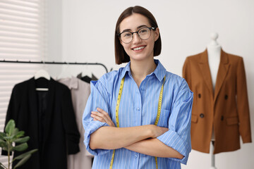 Wall Mural - Fashion designer with measuring tape in workshop