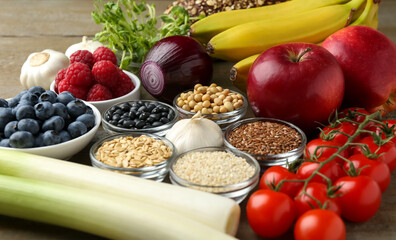 Canvas Print - Different fresh products on wooden table, closeup. Source of prebiotics