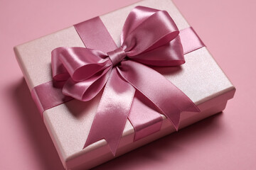 Sticker - Gift box with bow on dusty pink background, closeup