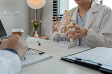 Wall Mural - two surgeons are sitting in a private office at a hospital discussing an upcoming major pelvic surgery, there was a discussion between the two doctors about the pelvic before the surgery, stethoscope