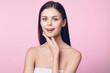© SHOTPRIME STUDIO - Beautiful young woman posing with hands on face on pink background in studio