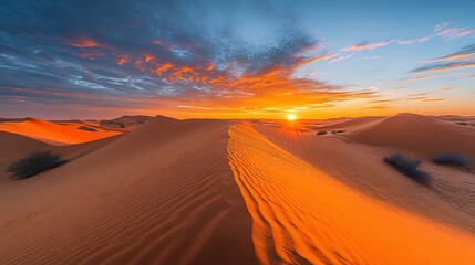 Canvas Print - sunrise over tranquil desert landscape with dunes and a sky filled with warm colors