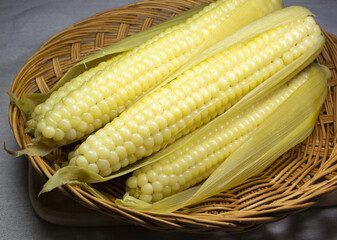 Wall Mural - Close-up of boiled corns with skin on bamboo basket, South Korea