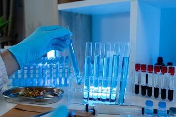 Wall Mural - a researcher is conducting scientific experiments on a liquid substance, a scientist is using labora