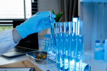 Wall Mural - a researcher is conducting scientific experiments on a liquid substance, a scientist is using labora