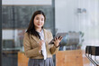 © SOMKID - Young asian businesswoman using tablet to startup projects and business presentation plan.