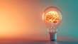 © kittikunfoto - A glowing brain inside a light bulb symbolizes the fusion of creativity and intelligence, depicting innovative thinking and bright ideas against a gradient background.