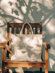 Beige tote bag on wooden chair with shaded background under a tree. Concepts of relaxation, minimalism, and eco-friendly accessories.