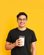© AnggiDimas - Portrait young man holding glass of milk happy smiling